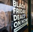 Black Friday Deals advertisement is shown on the storefront of a Columbia Sportswear Factory. Online shopping for Black Friday deals can have more potential risks. 
