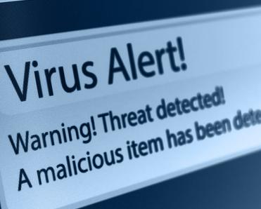 A close-up of a computer screen showing a virus alert that says a threat and malicious item has been detected