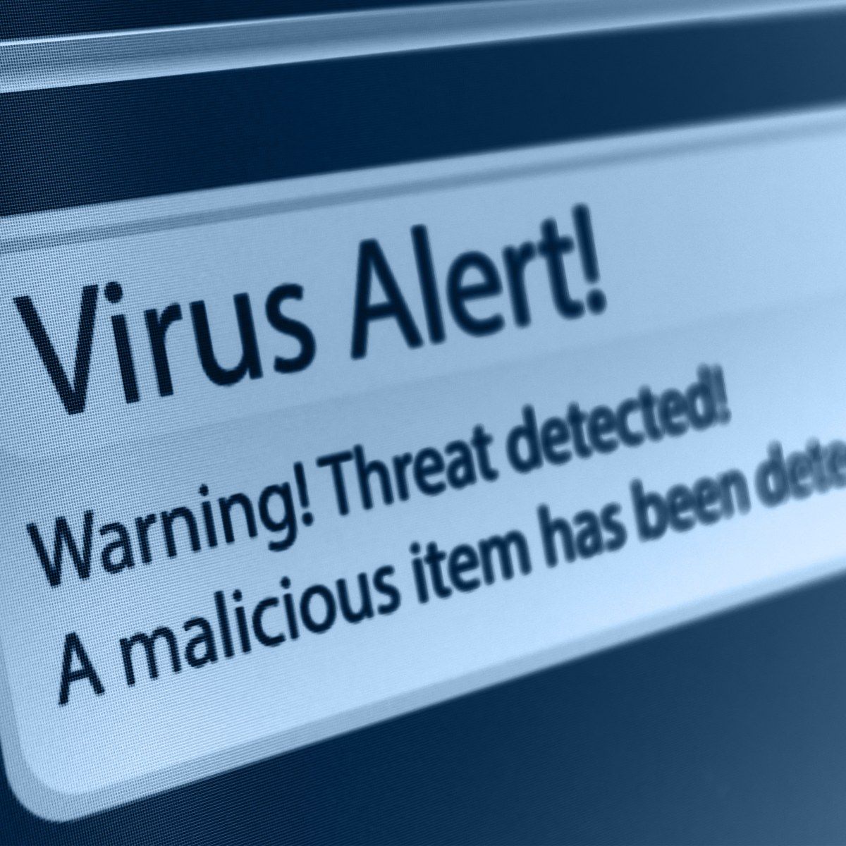 A close-up of a computer screen showing a virus alert that says a threat and malicious item has been detected