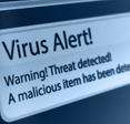 A close-up of a computer screen showing a virus alert that says a threat and malicious item has been detected