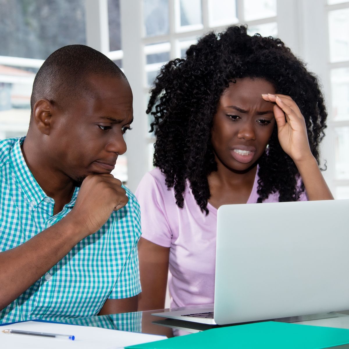 Concerned couple looking at laptop