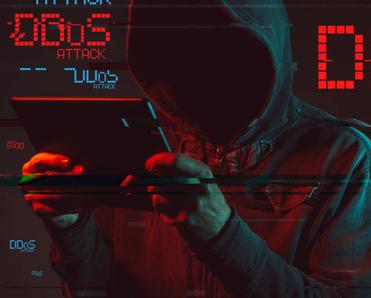 A hooded hacker uses a tablet to 