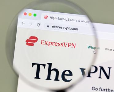 A magnifying glass zooms in on the ExpressVPN logo and homepage. ExpressVPN is one of the more expensive VPN subscriptions but offers reliability and secure features in exchange.