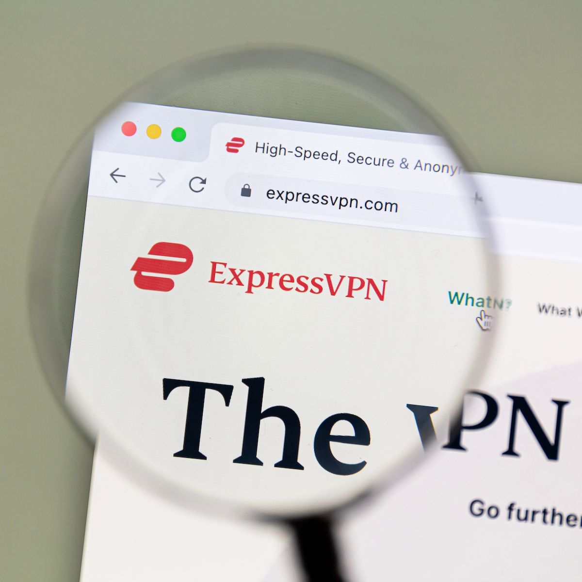 A magnifying glass zooms in on the ExpressVPN logo and homepage. ExpressVPN is one of the more expensive VPN subscriptions but offers reliability and secure features in exchange.