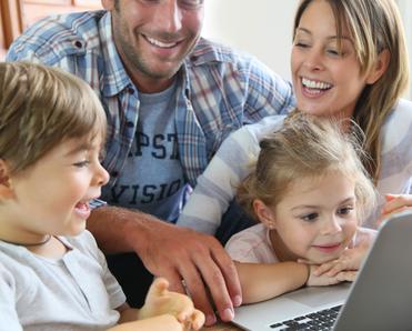 Family looking at a laptop