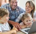 Family looking at a laptop