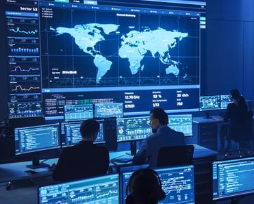 A surveillance room filled with people monitoring global data to represent the Five Eyes Alliance.