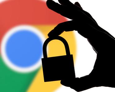 Google chrome logo blurred in the back with shadow hand holding lock in front