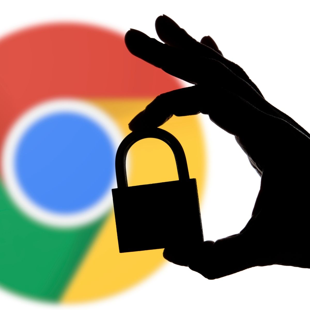 Google chrome logo blurred in the back with shadow hand holding lock in front