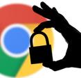 Google chrome logo blurred in the back with shadow hand holding lock in front