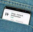 Phone in jeans pocket with dating app Hinge on the screen