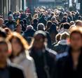 A front-facing photo of a mass of people walking to and fro on a crowded street used to illustrate the concept of browsing the internet anonymously.