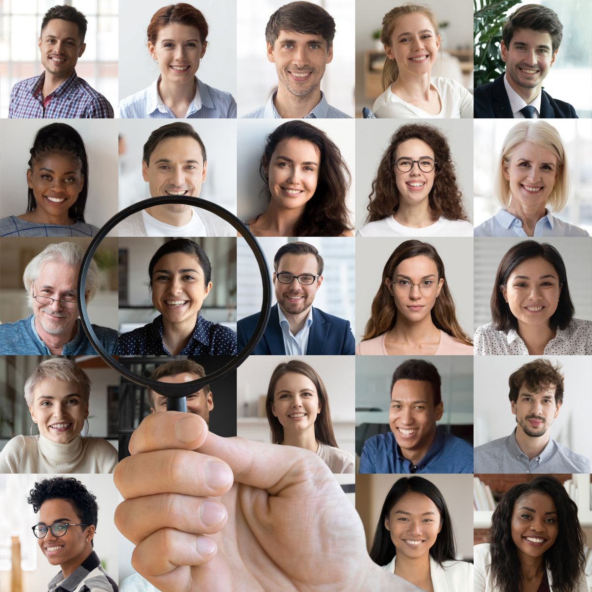 A hand holding a magnifying glass zooms in on a woman&#x27;s profile picture that&#x27;s surrounded by a handful of other men and women&#x27;s profile pics to signify people search.