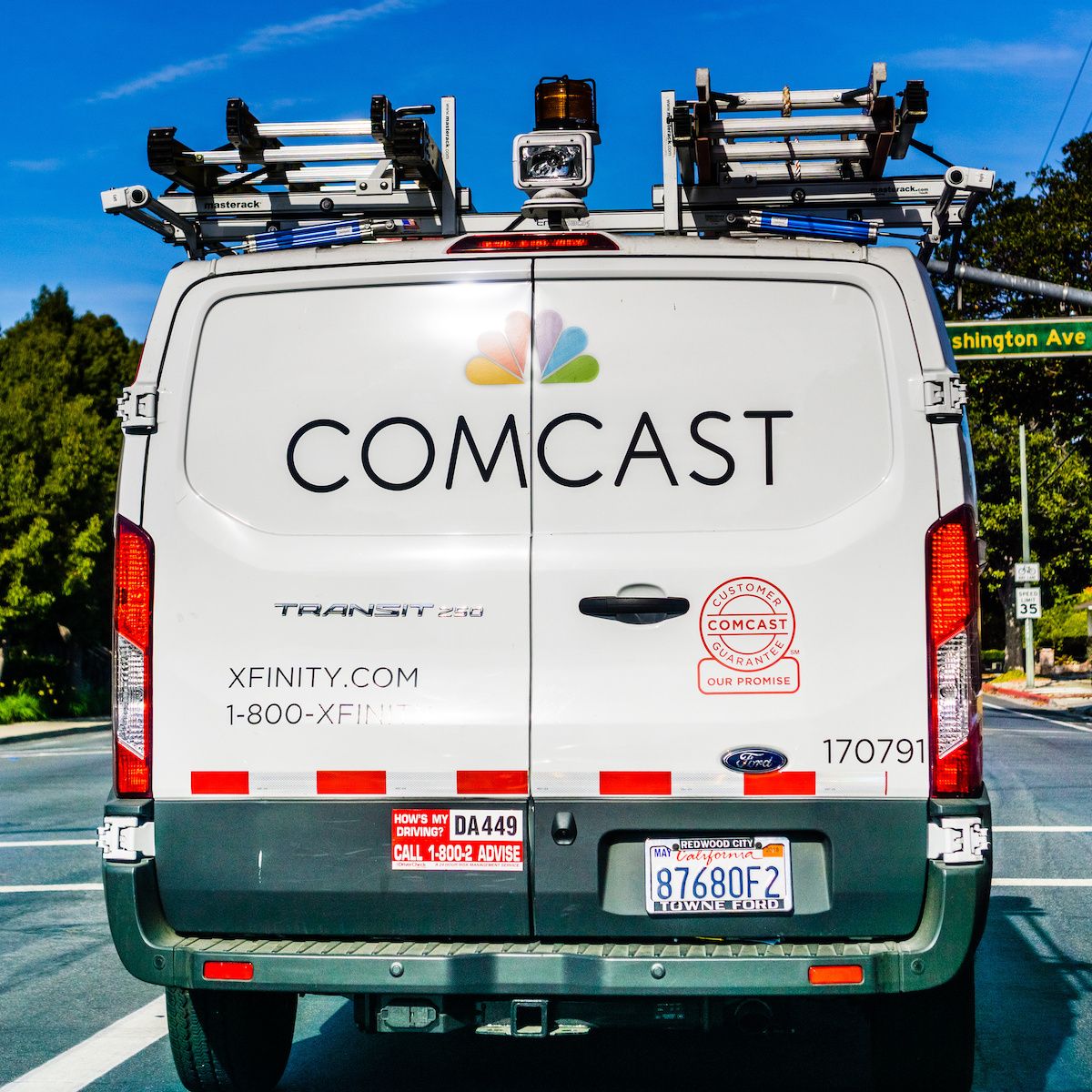 A Comcast Xfinity van drives along a street in the U.S. Switching internet providers could be a hassle, but with the right info, you could find a sweet deal.