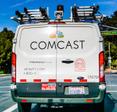 A Comcast Xfinity van drives along a street in the U.S. Switching internet providers could be a hassle, but with the right info, you could find a sweet deal.