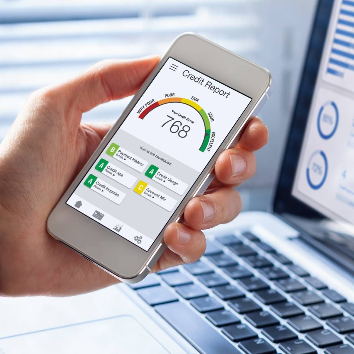 A person holding a smartphone and viewing their credit report with score rating app.