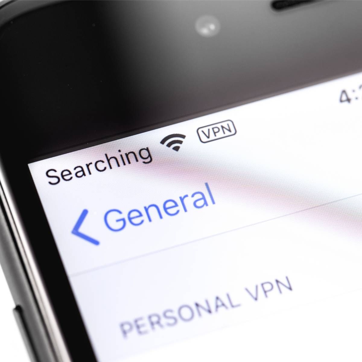 A close-up of an iPhone that is using a the VPN feature.