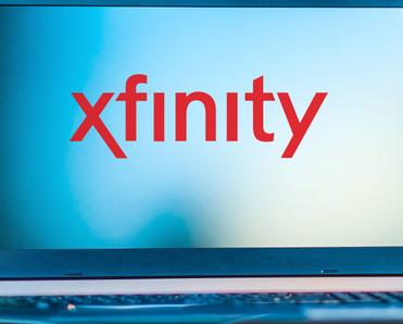 A laptop displaying the Xfinity logo.