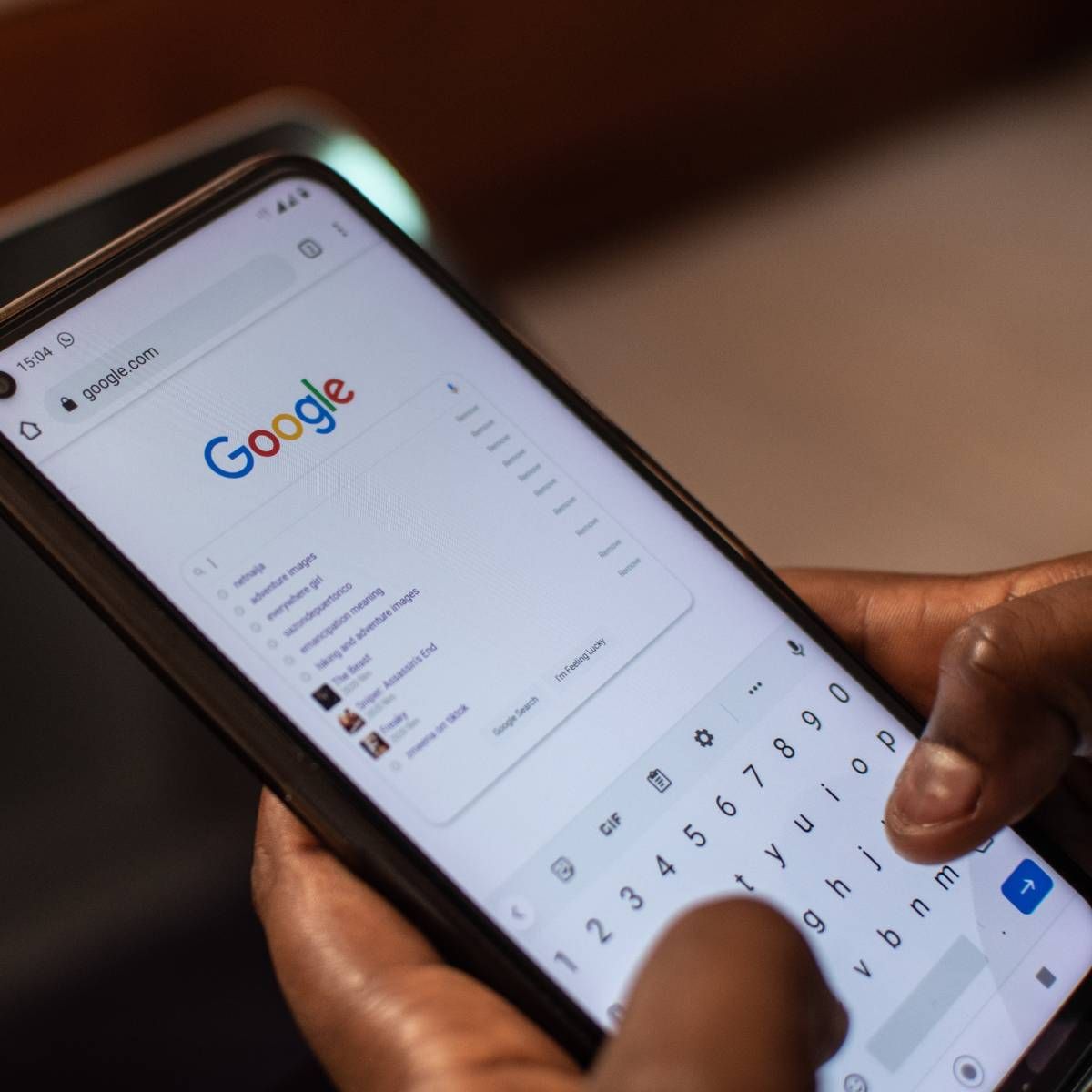 A person is using their smartphone to conduct a Google search.