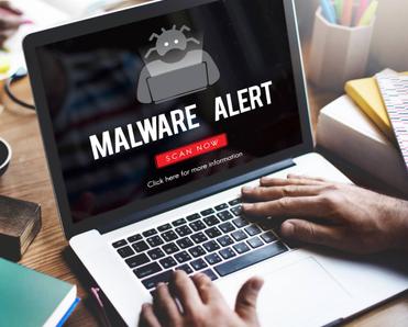 A laptop receiving a malware alert.