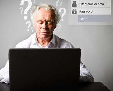 An older man sits at a laptop trying to remember his username and password