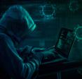 A hooded hacker on their laptop, sending out an online pandemic scam.