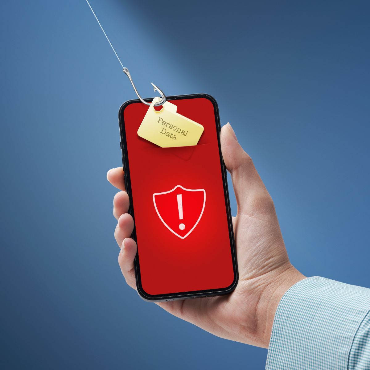 Hand holding phone with with shield and exclamation points on red screen a tag saying &quot;personal data&quot; is under a fishing hook trying to be pulled