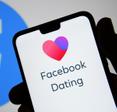 Phone screen with heart and Facebook Dating app
