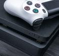 Black Ps4 console and white controller 