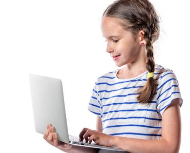 A young, blonde-haired girl stands holding a silver laptop to represent young children using the internet and social media