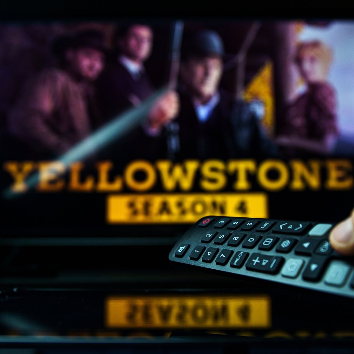 TV background with Yellowstone TV show on and remote control aimed at TV