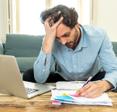 Stressed man looking at mail