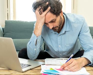 Stressed man looking at mail