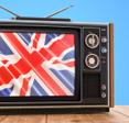An old TV set displays the British flag on the screen to represent watching BBC iPlayer with Surfshark VPN.