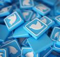 A pile of blue and white Twitter logo chips; Elon Musk plans to charge Twitter users a subscription fee for the verification checkmark on their profile. Here&#x27;s how U.S. adults feel about it.