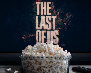 Tv in the background with The Last of Us on the screen and in front a bowl of popcorn and a remote control