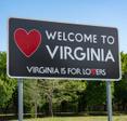 A roadside sign that says Welcome to Virginia and Virginia is for lovers with a red heart on the left-hand side.