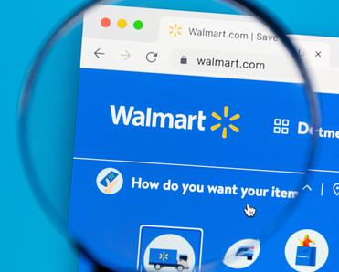 Home page Walmart website with magnifying glass zooming on logo