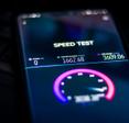 A close-up of a cell phone screen showing an internet speed test result with 0 ping, 1,662 Mbps download speed, and 3,609 Mbps upload speed.