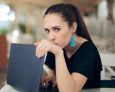 woman hiding her laptop screen