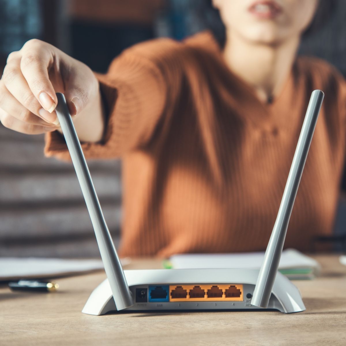 Woman adjusting router
