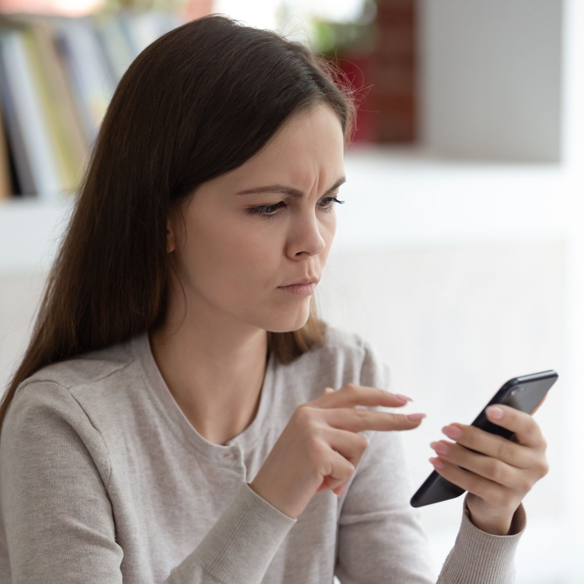 Woman looking upset at phone