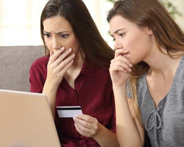 Women looking at computer nervously