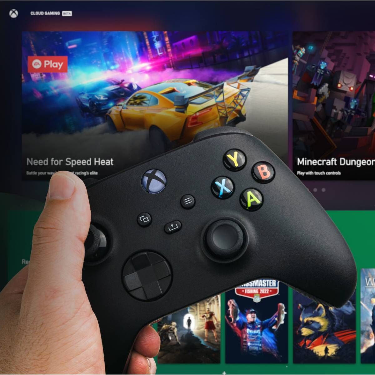 Man holding an Xbox controller with Cloud Gaming Pass blurred in the background. 