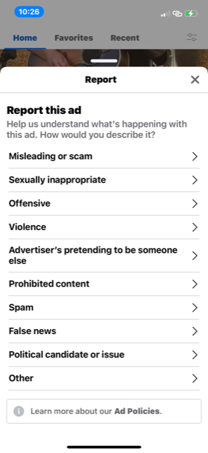 A screenshot of the menu that comes up when you click to report a Facebook ad. Reasons listed for reporting an ad include scam, offensive, violence, spam, and more.